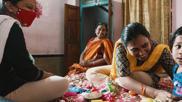 Sruti (second from right) has been supported to care for her children at home with the help of the government of India, Changing the Way We Care, and local partners.