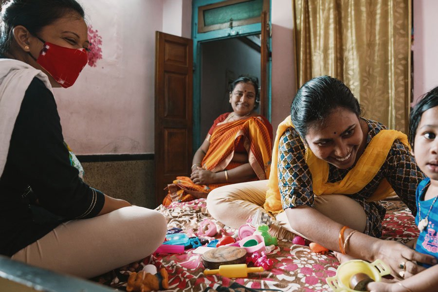 Sruti (second from right) has been supported to care for her children at home with the help of the government of India, Changing the Way We Care, and local partners.