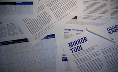 A pile of papers is laid out on a table in an overlapping fashion; one of the papers is titled "Mirror Tool" at the top