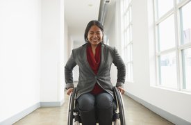 Smiling woman in a wheel chair.