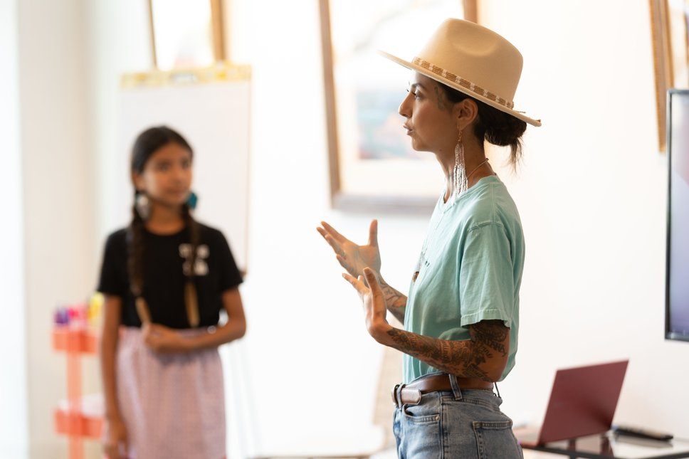 Rocio Francis, founder of Morning Mist Soap Co. speaks at a Circle of Support event as her daughter looks on.