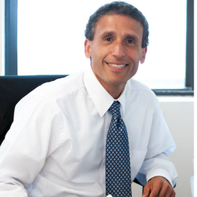 An image of Plinio Ayala, President and CEO of Per Scholas, smiling at the camera